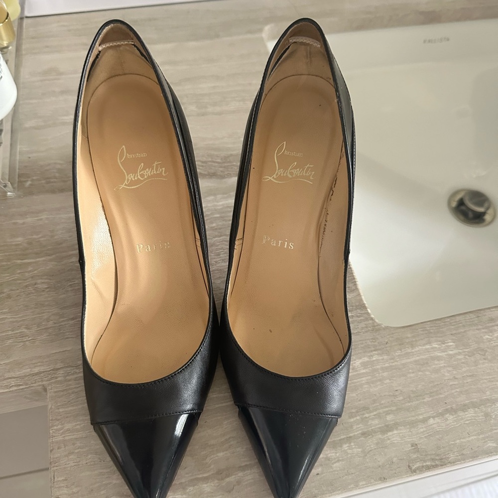 Louboutins black leather pumps